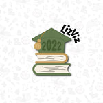 Graduation Cookie Cutter. Stack of books with graduation cap.